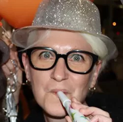 Kyra Pieterse wearing glasses and a silver party hat